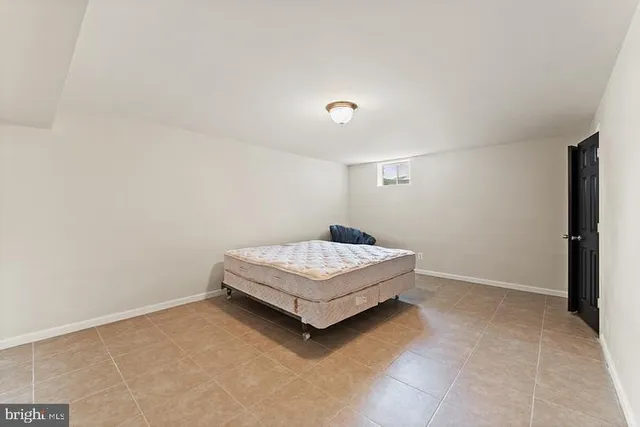 a living room with a rug and a window
