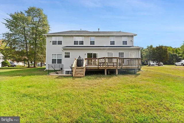 a view of a house with swimming pool and sitting area
