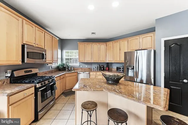 a kitchen with a stove a sink and a refrigerator