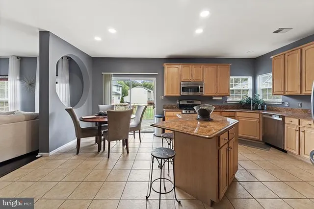 a kitchen with a sink a counter top space cabinets and stainless steel appliances