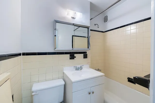 a bathroom with a sink a toilet and mirror