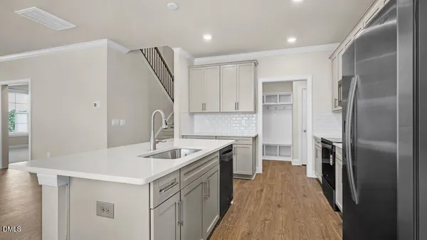 a kitchen with refrigerator cabinets and a sink