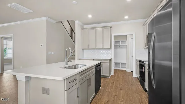a kitchen with refrigerator cabinets and a sink
