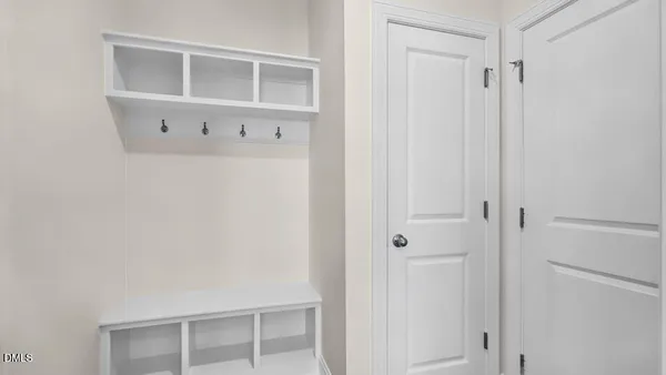 a view of kitchen with kitchen island white cabinets and wooden floor