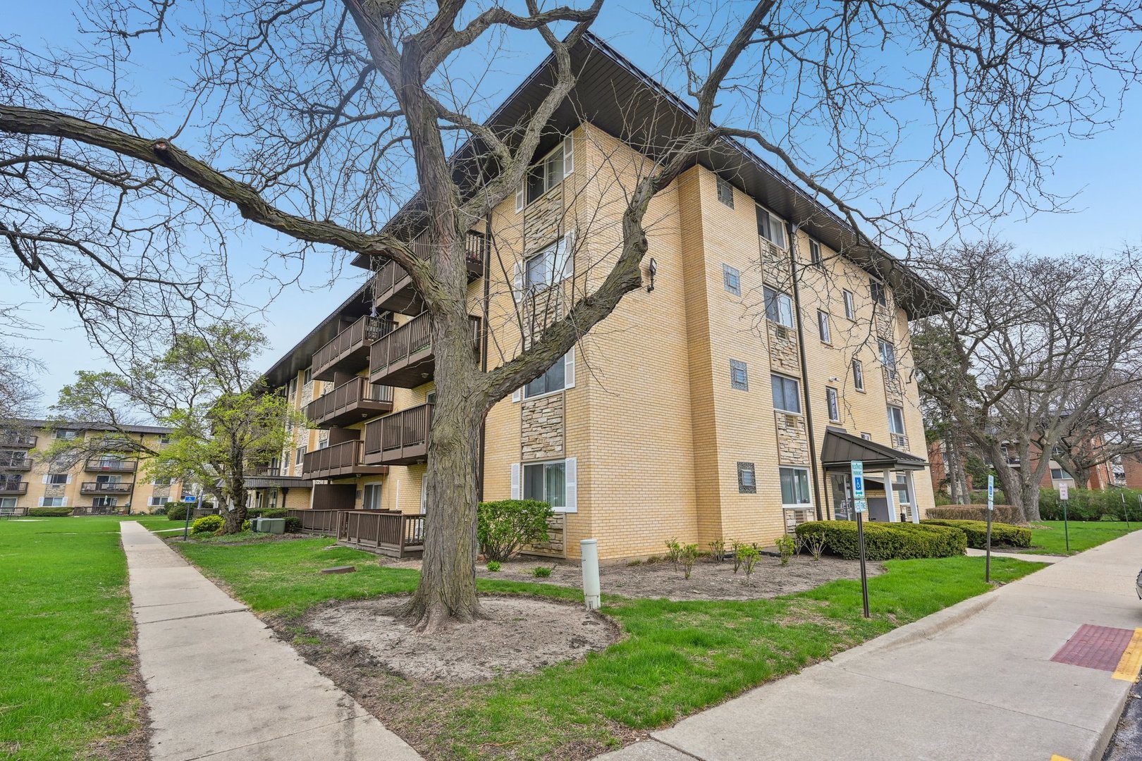 2226 South Goebbert Road, Unit 172 Arlington Heights, IL 60005 - Photo 2 of 22 a view of a building with a yard