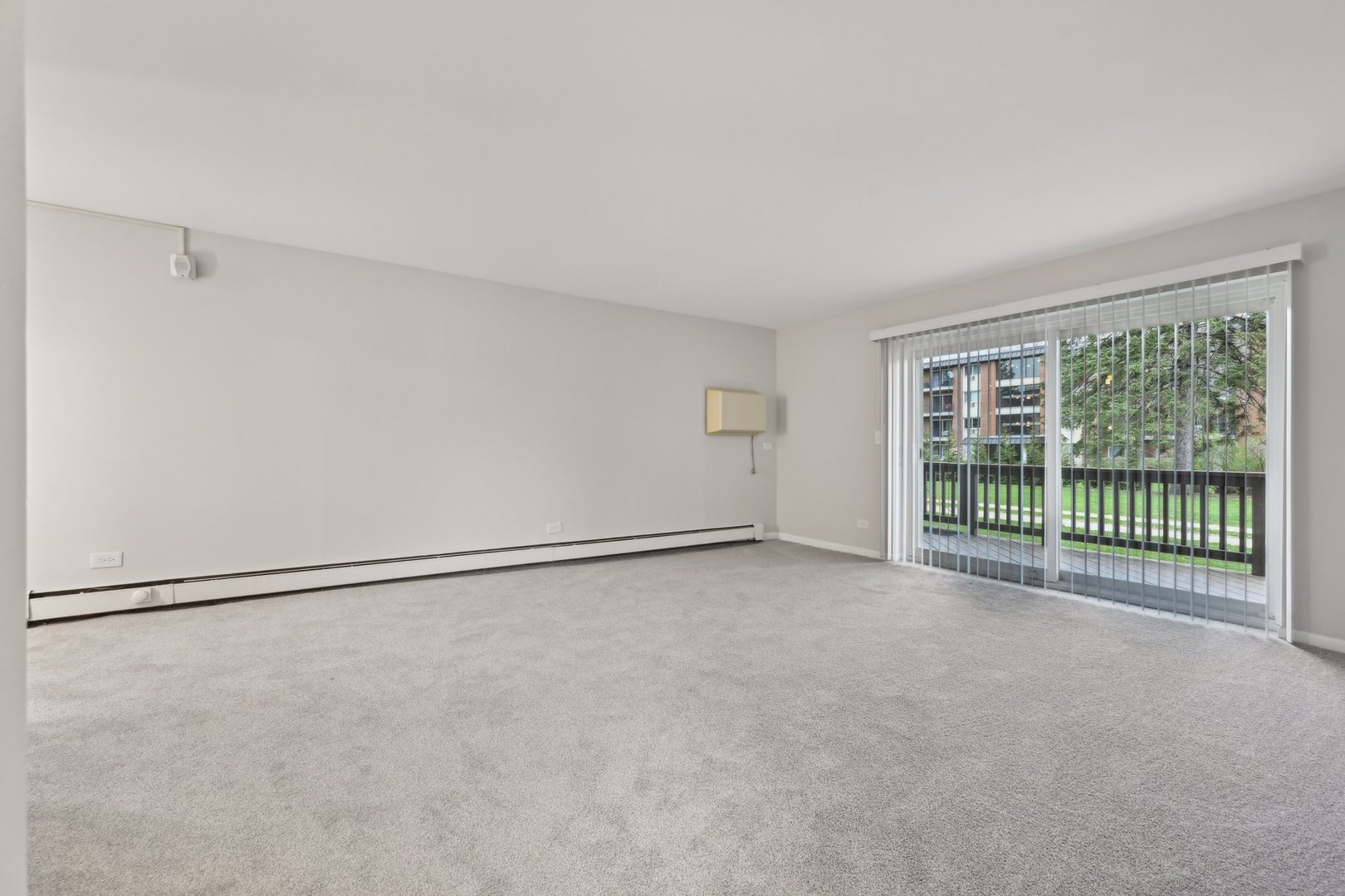2226 South Goebbert Road, Unit 172 Arlington Heights, IL 60005 - Photo 4 of 22 a view of an empty room with a window