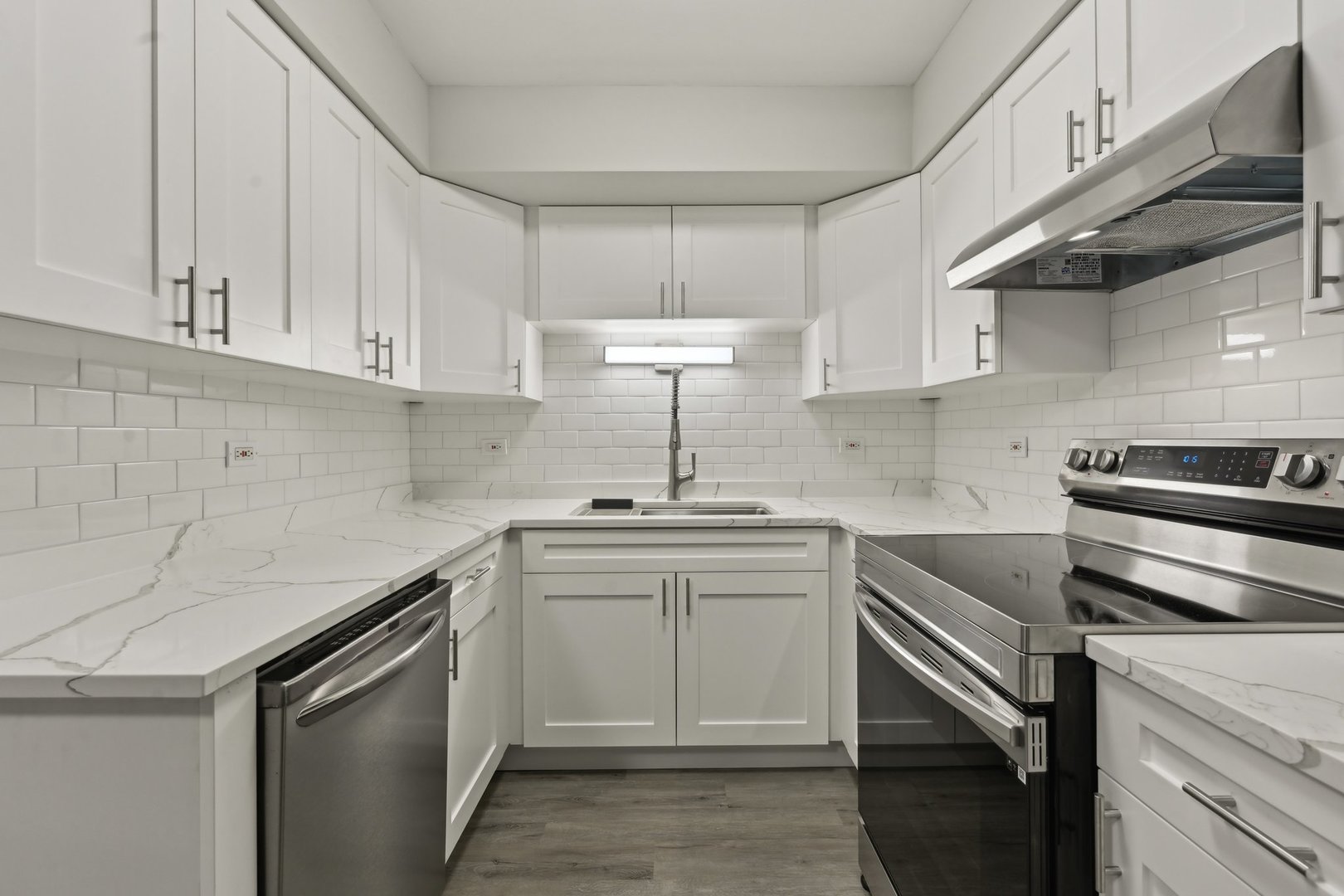 2226 South Goebbert Road, Unit 172 Arlington Heights, IL 60005 - Photo 8 of 22 a kitchen with a sink stove and cabinets