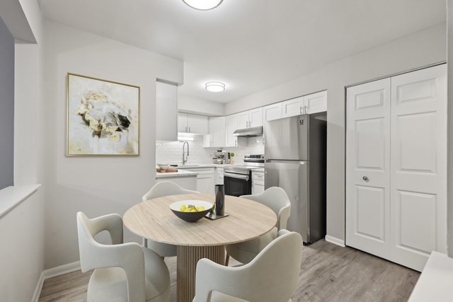 2226 South Goebbert Road, Unit 172 Arlington Heights, IL 60005 - Photo 9 of 22 a view of a dining room with furniture and a kitchen