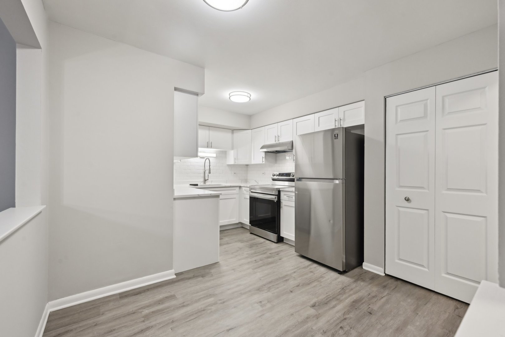 2226 South Goebbert Road, Unit 172 Arlington Heights, IL 60005 - Photo 10 of 22 a kitchen with white cabinets and stainless steel appliances