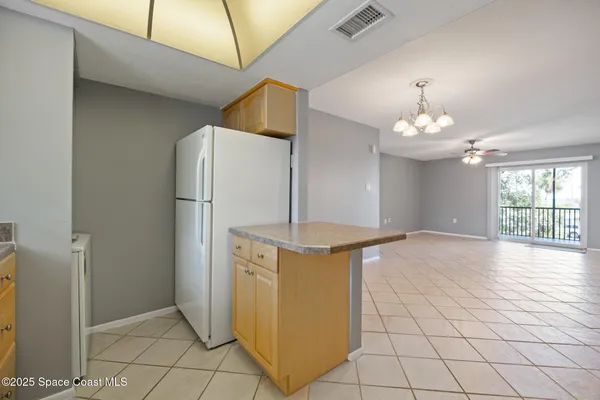 a view of a kitchen with furniture and chandelier