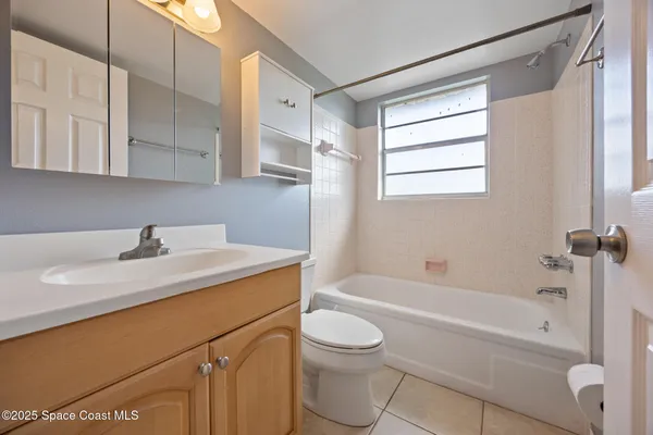 a bathroom with a sink toilet vanity and bathtub