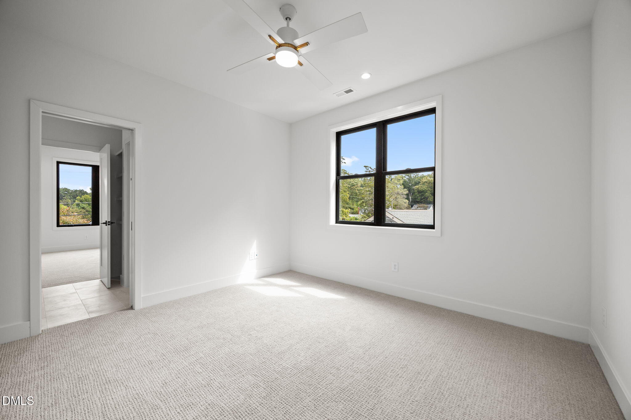 406 Columbia Drive Raleigh, NC 27604 - Photo 39 of 47 an empty room with a window and a ceiling fan