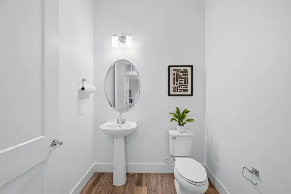 a bathroom with a toilet a sink and a mirror