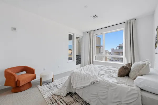 a bedroom with a bed and glass window
