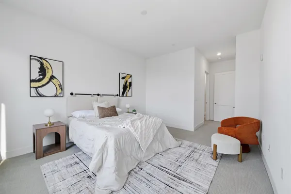 a bedroom with a bed and painting on the wall