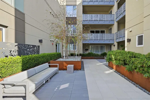 a front view of a building with multi story residential apartment building in the back