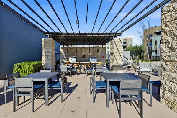 a view of a patio with a table and chairs