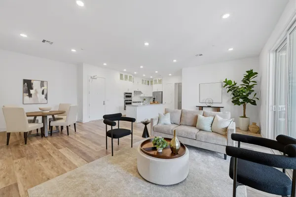 a living room with furniture and a potted plant