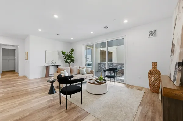 a living room with furniture and wooden floor