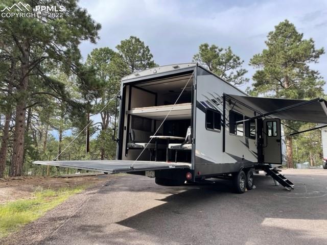 34135 Berndt Road Yoder, CO 80864 - Photo 20 of 24 a house with trees in the background