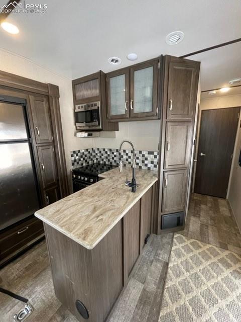 34135 Berndt Road Yoder, CO 80864 - Photo 6 of 24 a kitchen with granite countertop a refrigerator and a sink