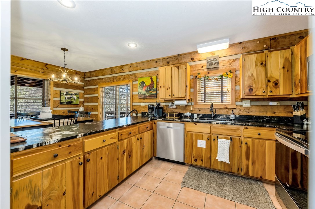 251 Stone Valley Road Grassy Creek, NC 28631 - Photo 11 of 46 a large kitchen with stainless steel appliances granite countertop a stove a sink and a refrigerator