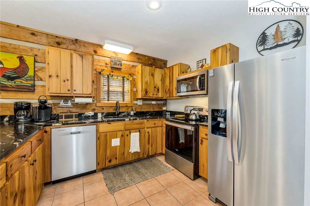 251 Stone Valley Road Grassy Creek, NC 28631 - Photo 12 of 46 a kitchen with stainless steel appliances granite countertop a refrigerator and a stove top oven