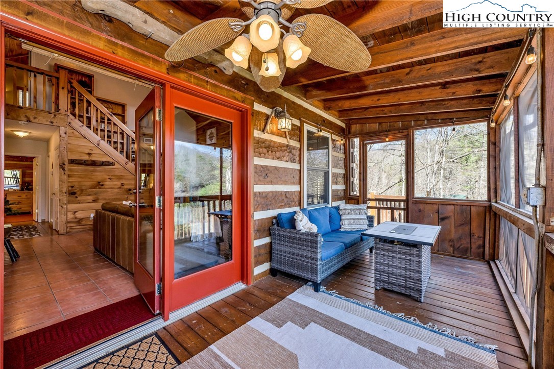 251 Stone Valley Road Grassy Creek, NC 28631 - Photo 16 of 46 a balcony with furniture and wooden floor