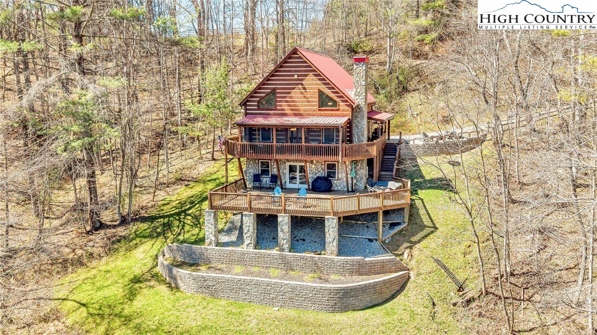251 Stone Valley Road Grassy Creek, NC 28631 - Photo 2 of 46 a view of a house with pool and sitting area