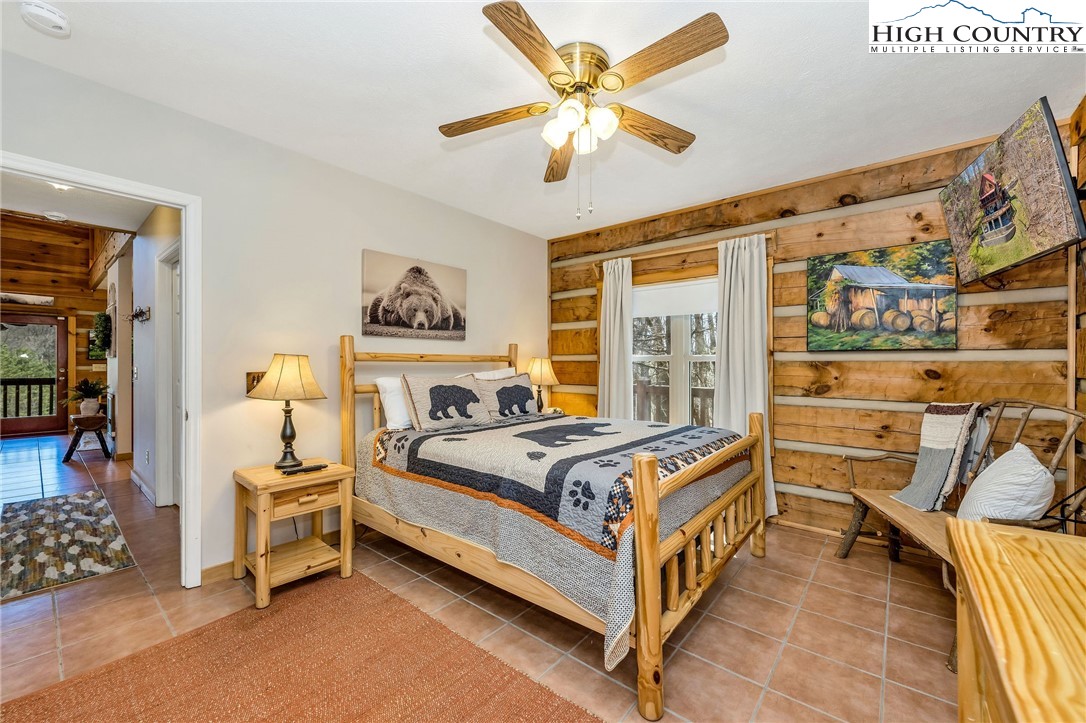 251 Stone Valley Road Grassy Creek, NC 28631 - Photo 21 of 46 a bed room with a bed and a window