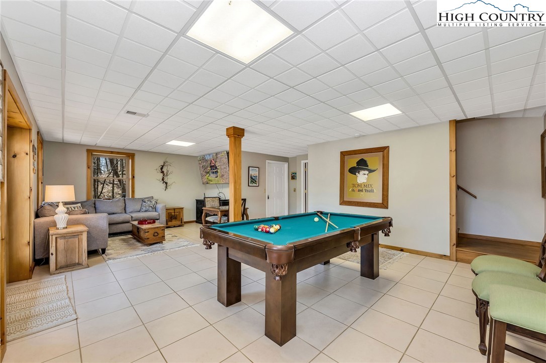 251 Stone Valley Road Grassy Creek, NC 28631 - Photo 34 of 46 a living room with furniture pool table and a table