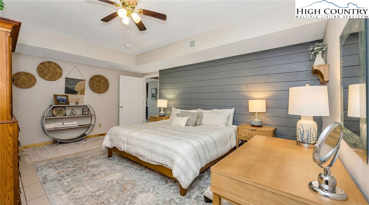 251 Stone Valley Road Grassy Creek, NC 28631 - Photo 38 of 46 a bedroom with a bed and ceiling fan