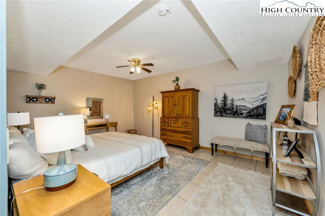 251 Stone Valley Road Grassy Creek, NC 28631 - Photo 39 of 46 a bedroom with furniture and a flat screen tv