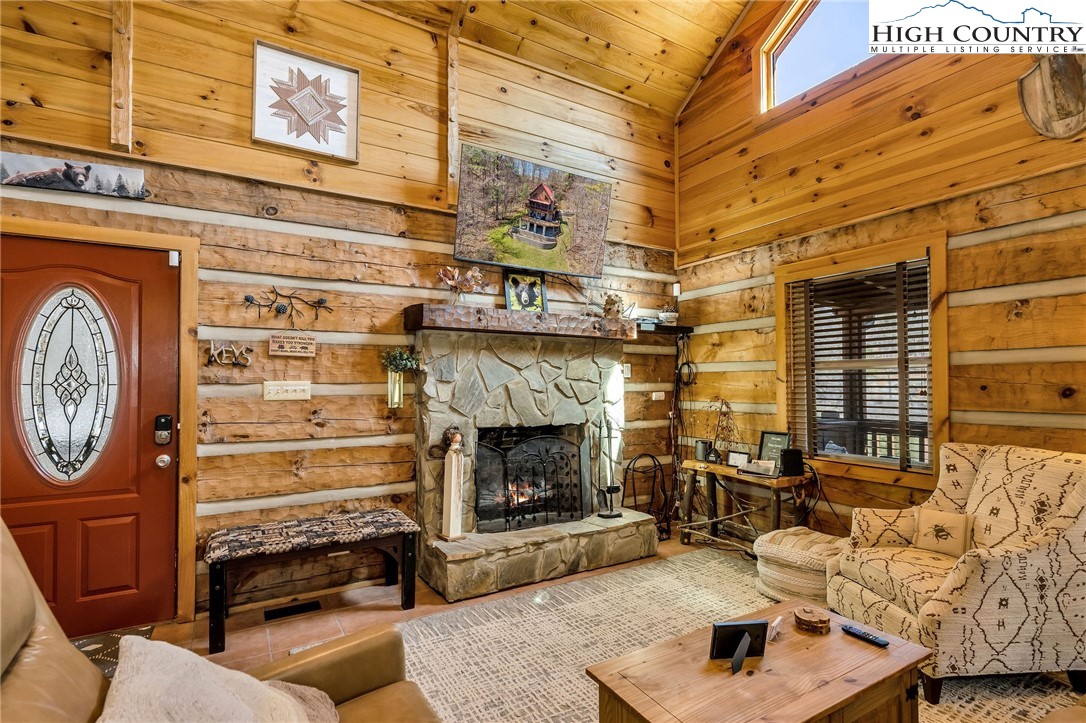 251 Stone Valley Road Grassy Creek, NC 28631 - Photo 6 of 46 a living room with furniture and a fireplace