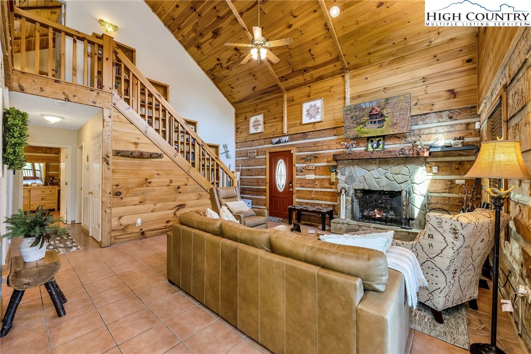 251 Stone Valley Road Grassy Creek, NC 28631 - Photo 7 of 46 a living room with furniture a fireplace and a table