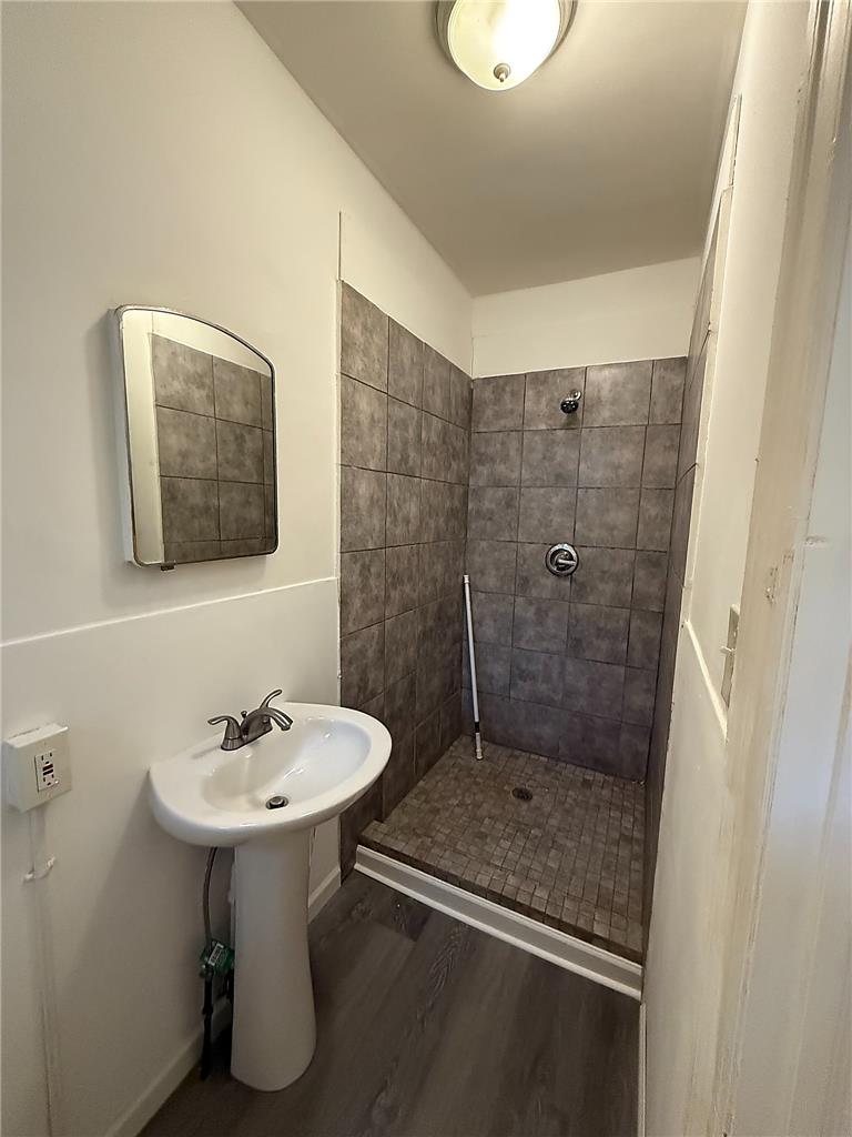 5107 Cottage Street, Unit 1 Philadelphia, PA 19124 - Photo 4 of 7 A compact bathroom offers essential fixtures and tiled shower for convenient living.