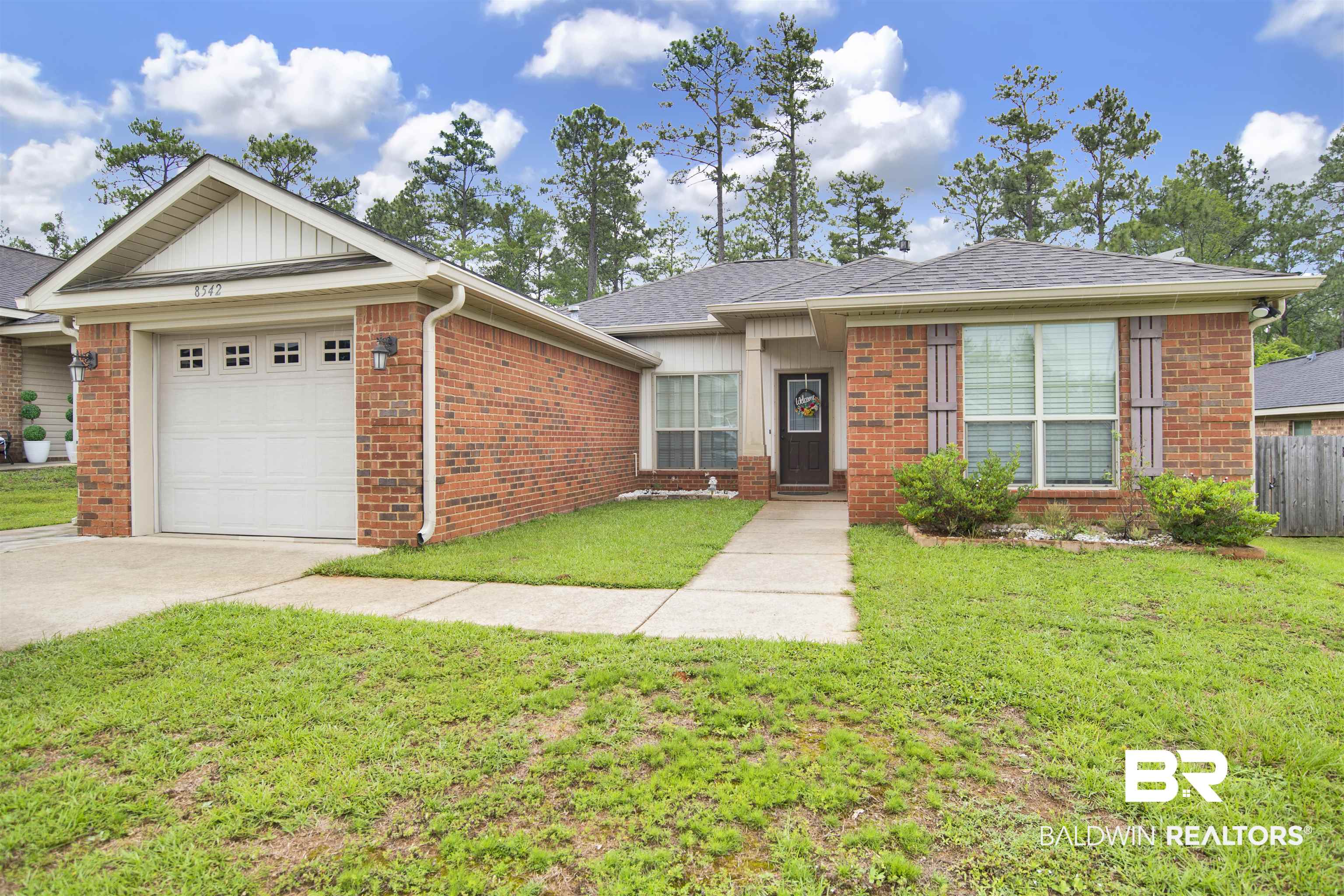 8542 Three Dean Way Mobile, AL 36695 - Photo 1 of 26 Ranch-style home featuring brick siding, an attached garage, concrete driveway, and roof with shingles