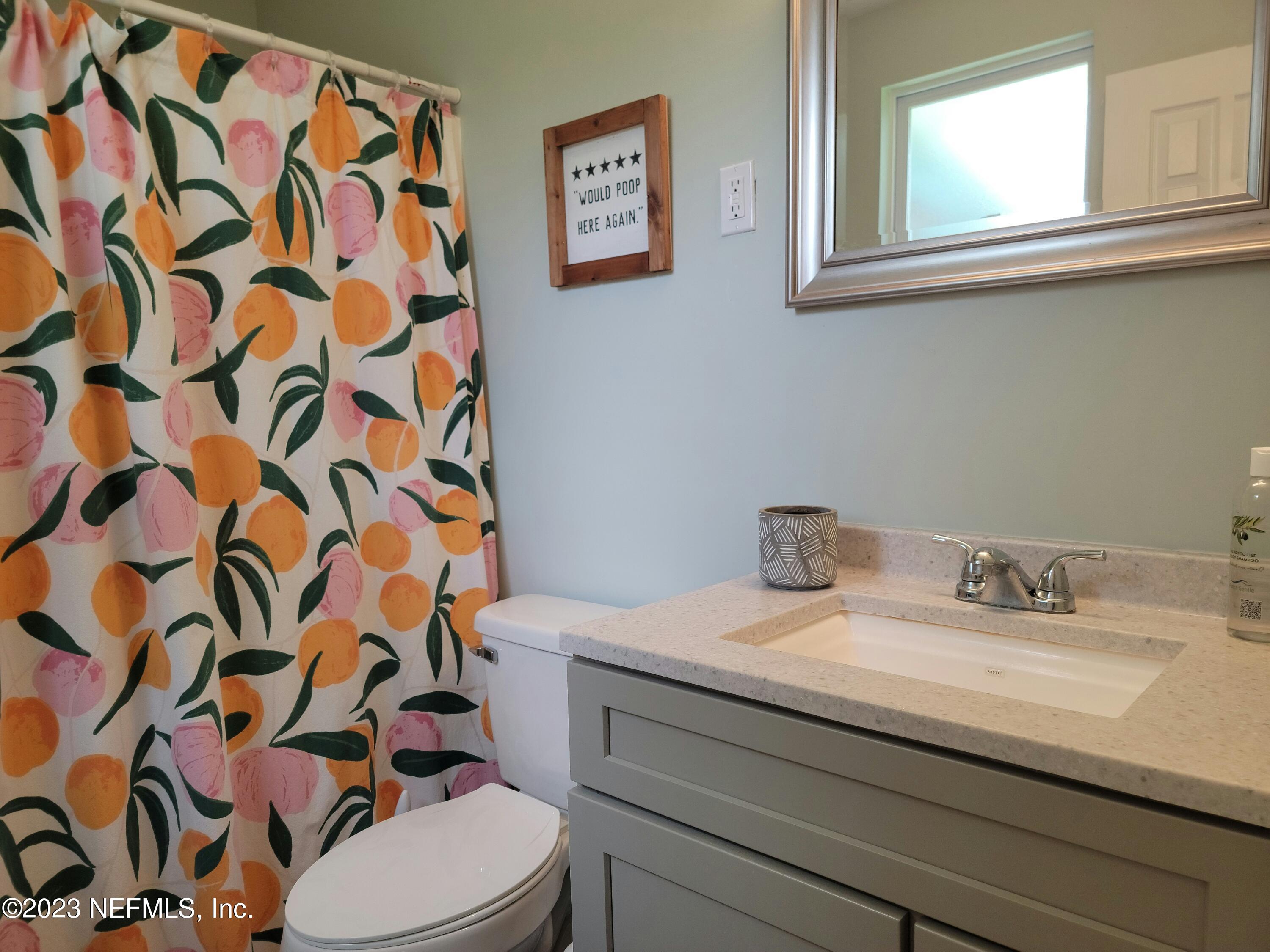 5452 Community Road Jacksonville, FL 32207 - Photo 11 of 23 a bathroom with a sink toilet and shower curtain