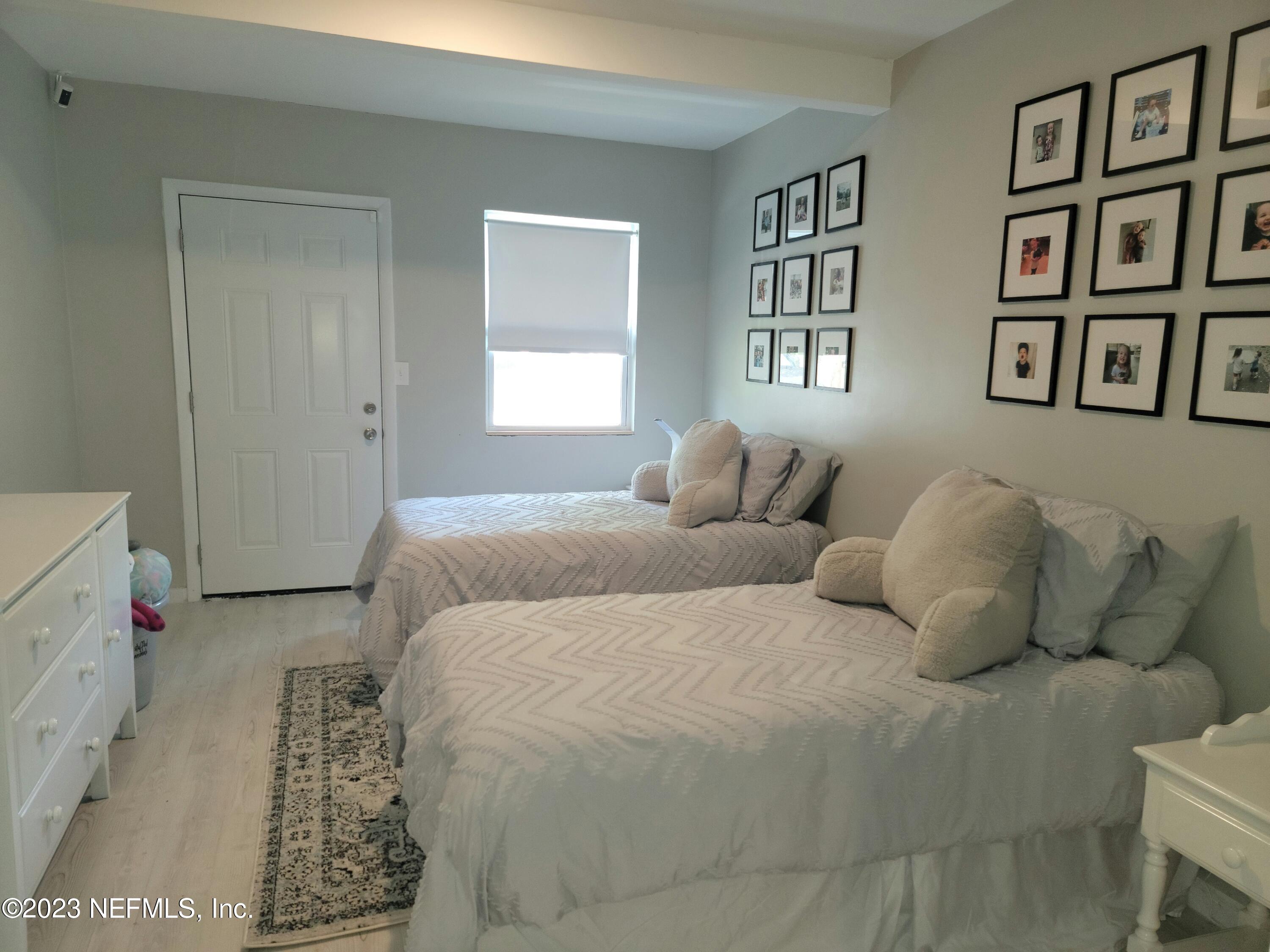5452 Community Road Jacksonville, FL 32207 - Photo 16 of 23 a bedroom with a bed and a window