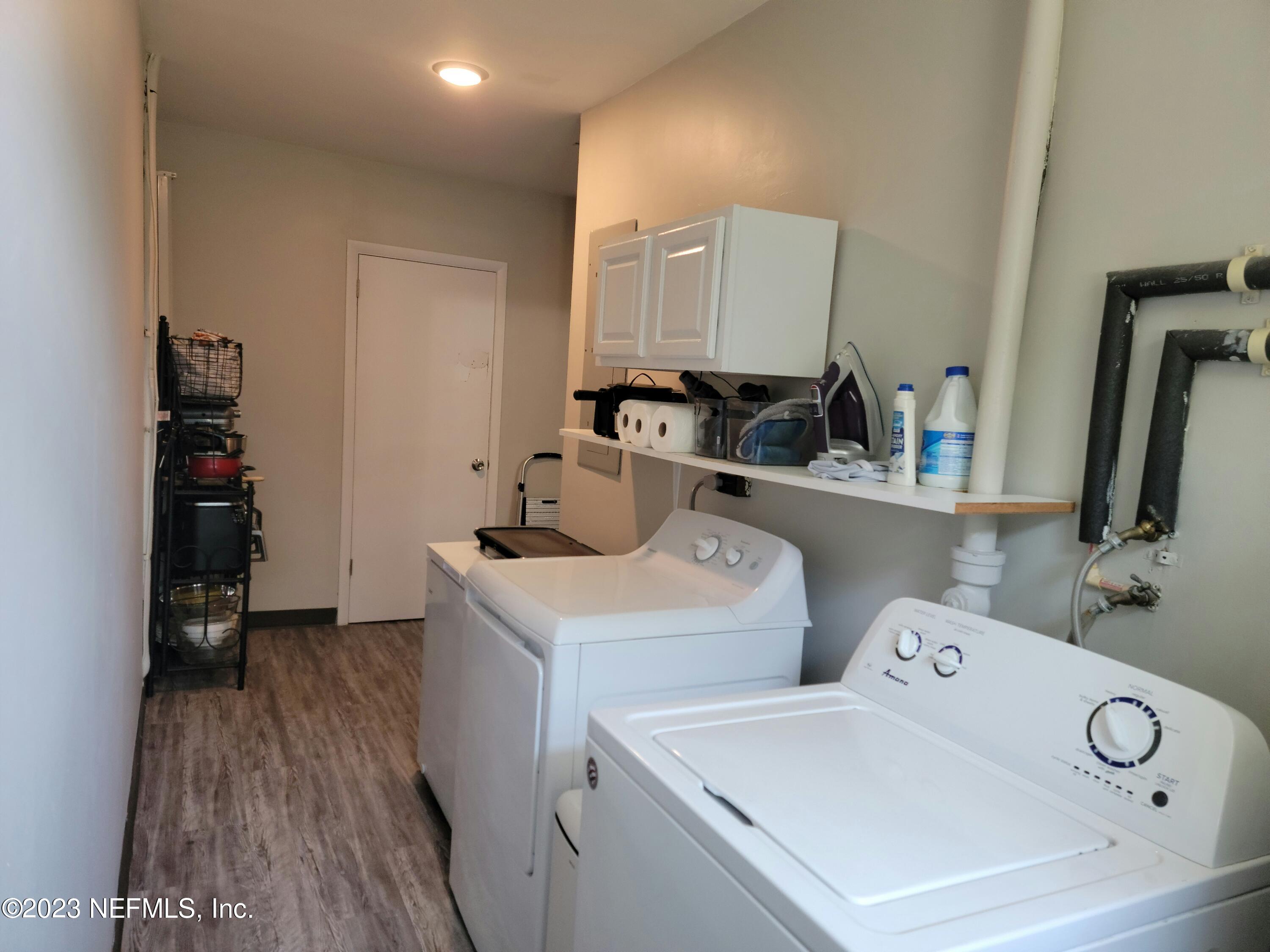 5452 Community Road Jacksonville, FL 32207 - Photo 17 of 23 a view of washer and dryer with kitchen in the background