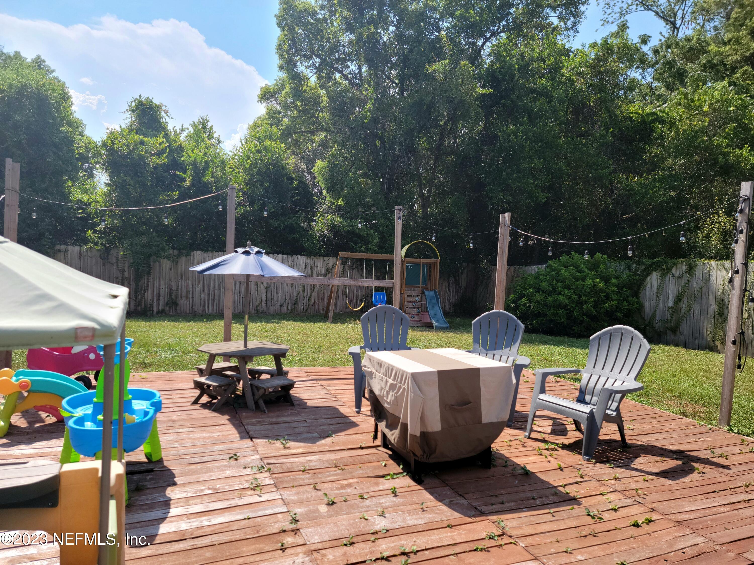 5452 Community Road Jacksonville, FL 32207 - Photo 19 of 23 a view of a patio with couches chairs and a potted plant