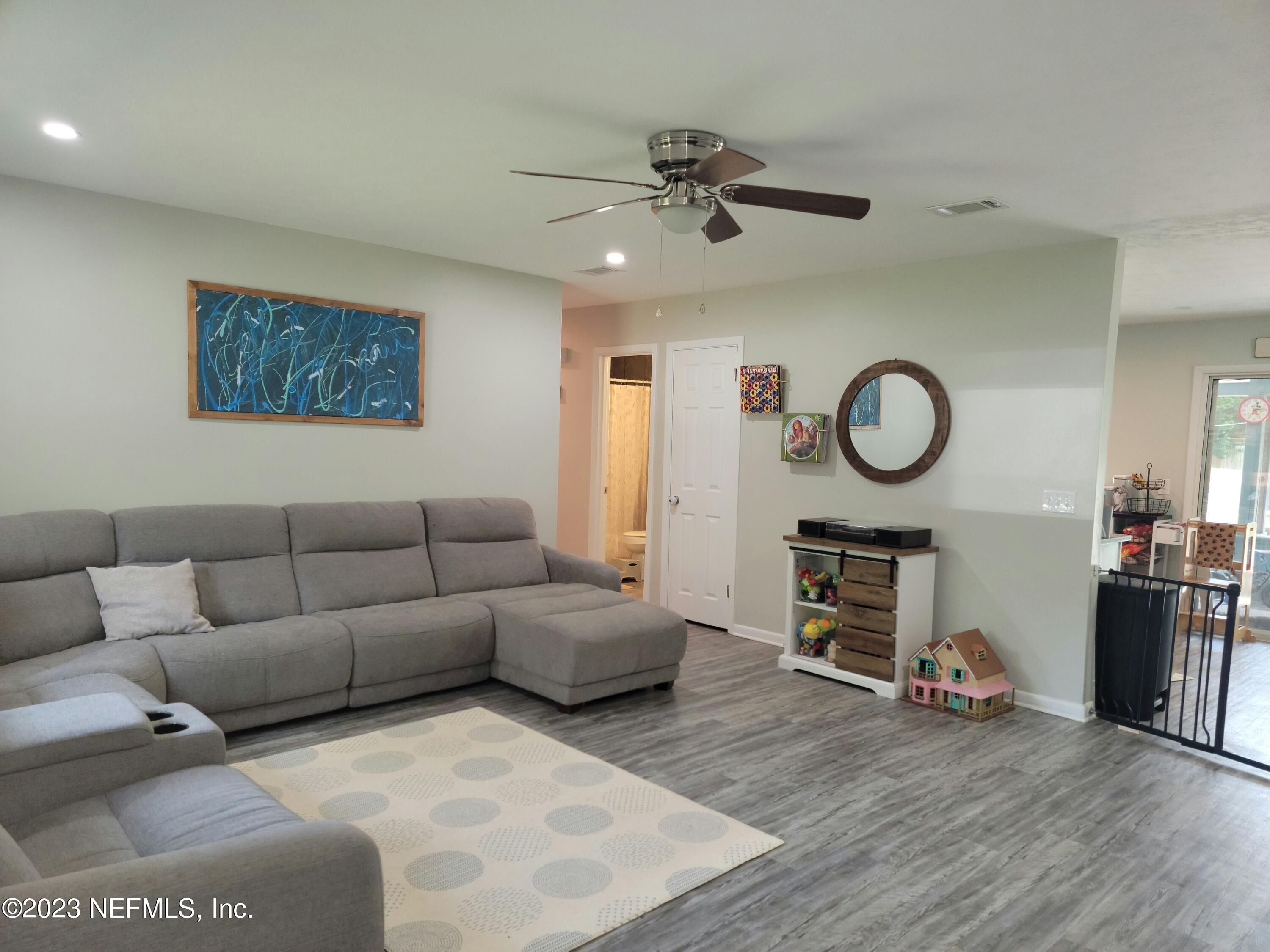 5452 Community Road Jacksonville, FL 32207 - Photo 2 of 23 a living room with furniture and a wooden floor