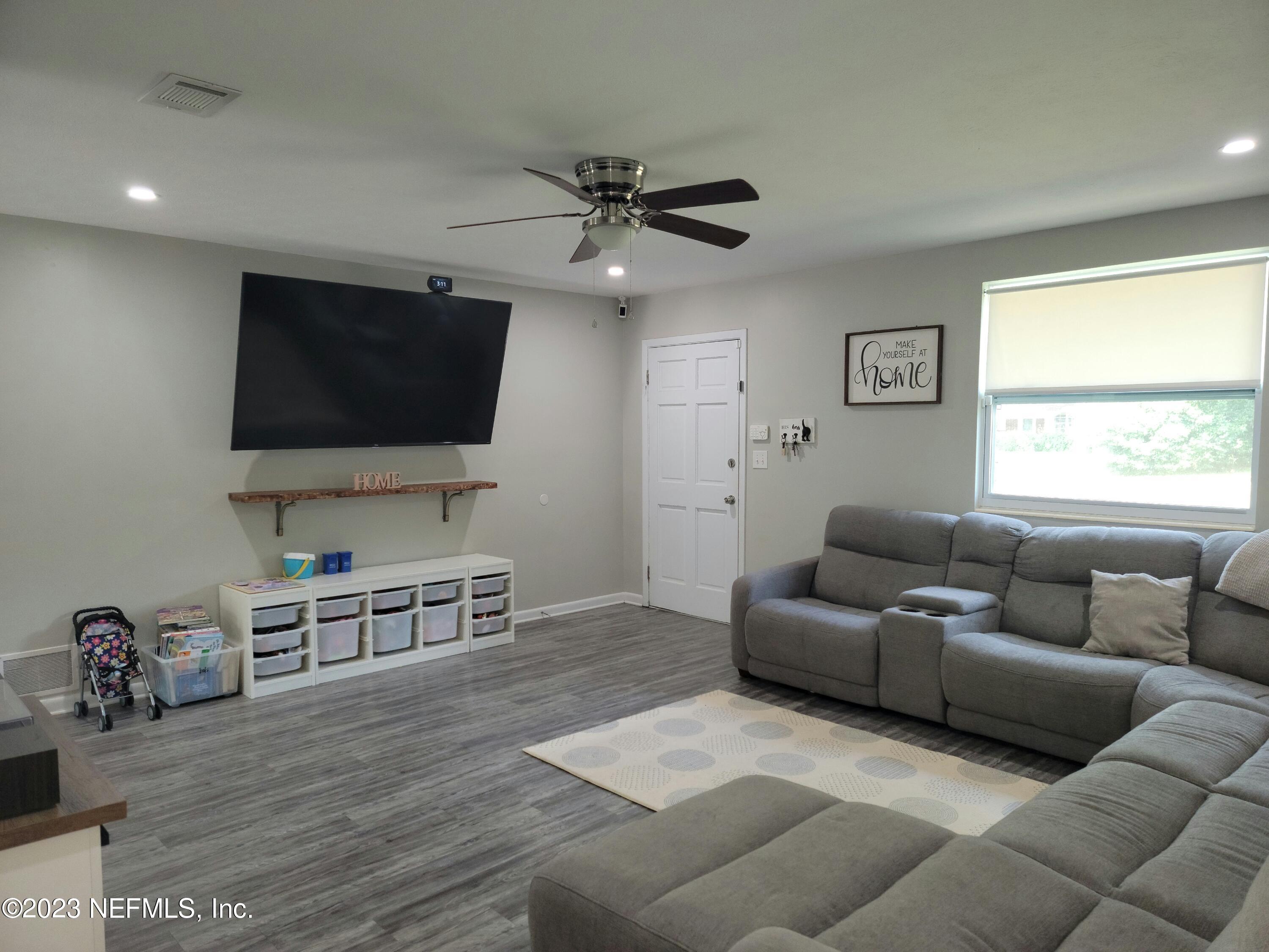 5452 Community Road Jacksonville, FL 32207 - Photo 4 of 23 a living room with furniture and a flat screen tv