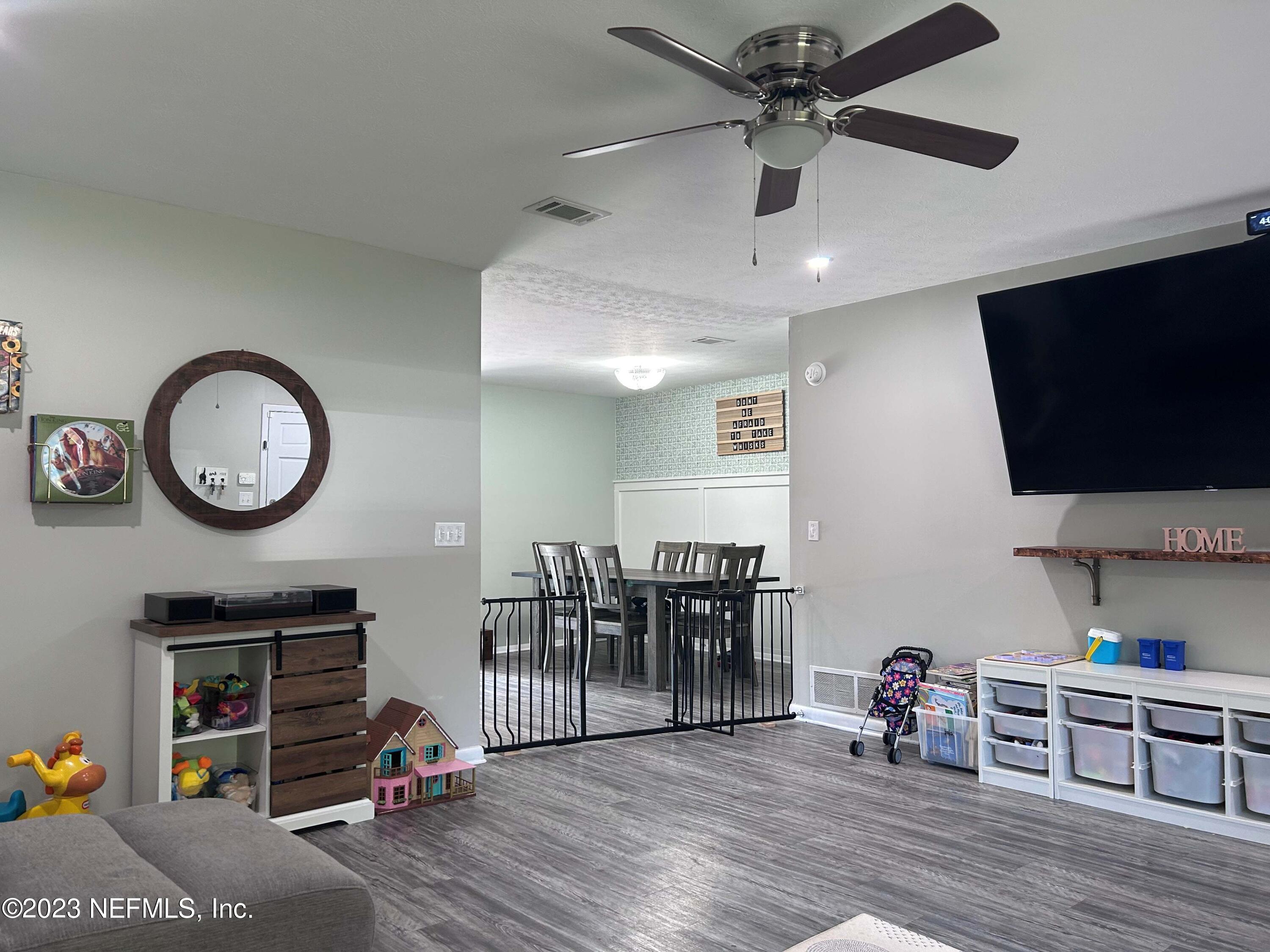 5452 Community Road Jacksonville, FL 32207 - Photo 5 of 23 a view of a livingroom and a dining room with wooden floor