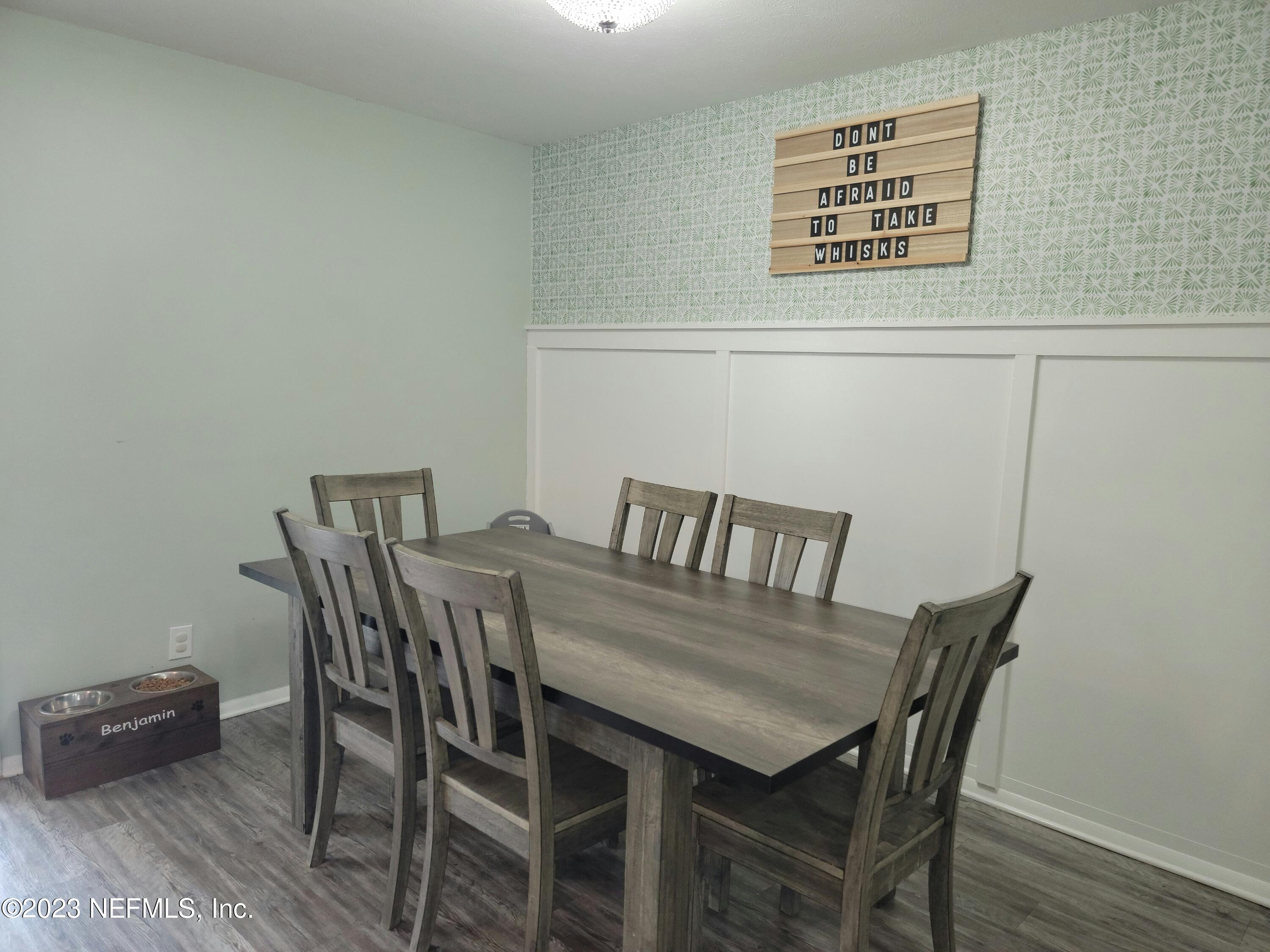 5452 Community Road Jacksonville, FL 32207 - Photo 6 of 23 a view of a dining room with furniture and wooden floor
