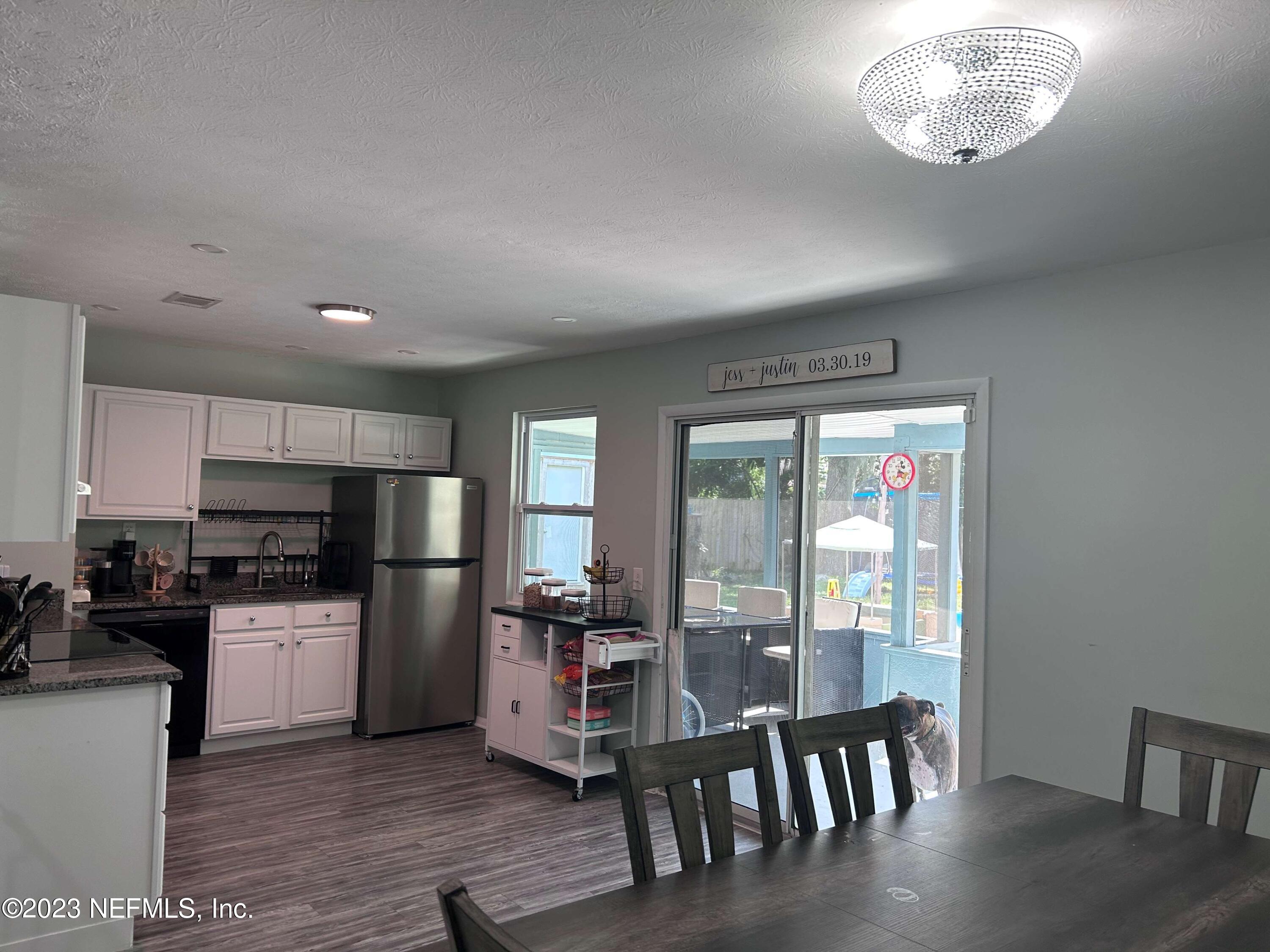 5452 Community Road Jacksonville, FL 32207 - Photo 8 of 23 a kitchen with stainless steel appliances a refrigerator and wooden floor