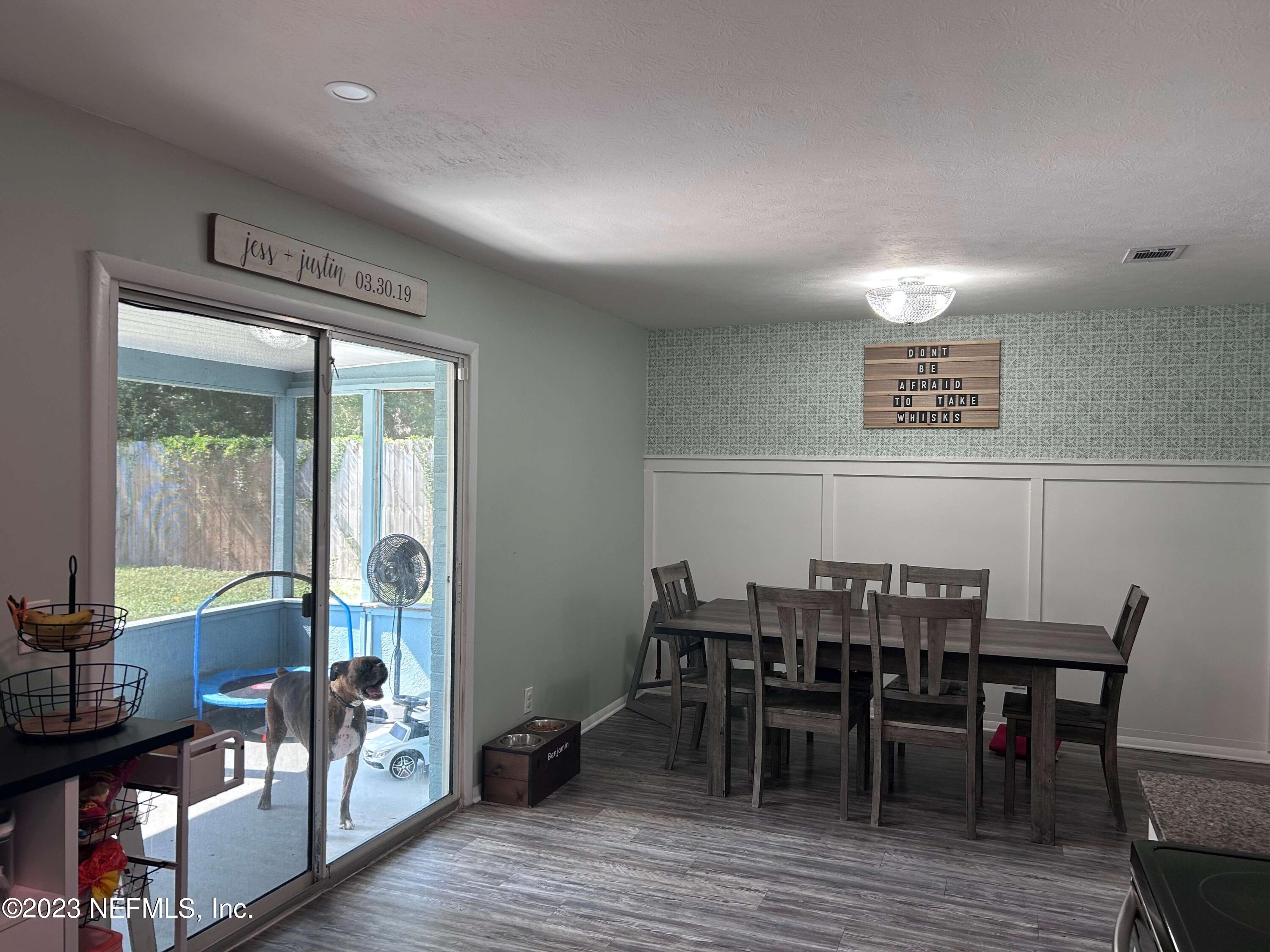 5452 Community Road Jacksonville, FL 32207 - Photo 9 of 23 a view of a dining room with furniture and wooden floor