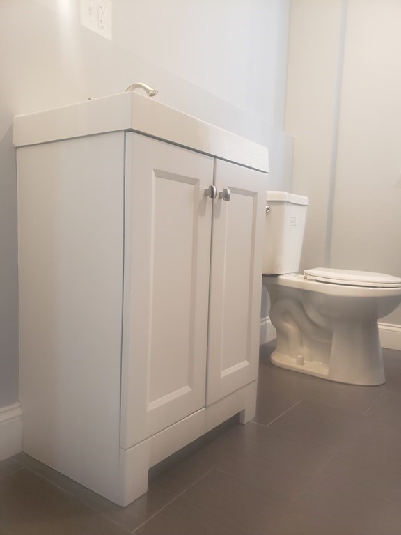 19 Wareham Street Springfield, MA 01108 - Photo 11 of 25 a bathroom with a shower a toilet and a sink