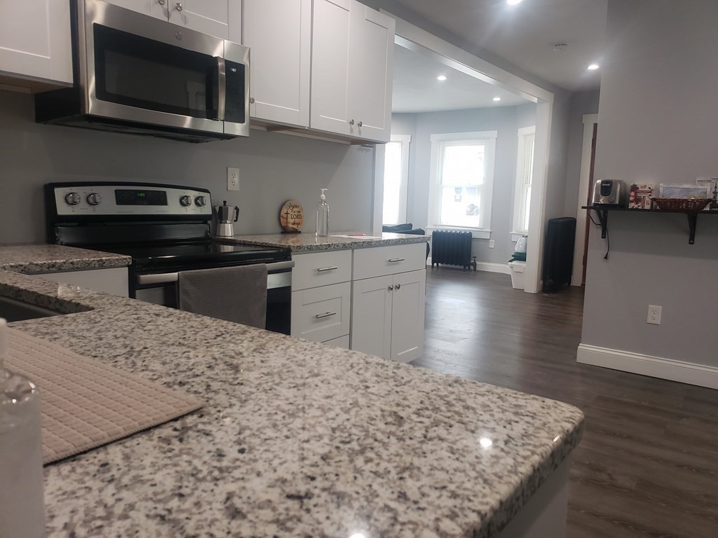 19 Wareham Street Springfield, MA 01108 - Photo 5 of 25 a kitchen with stainless steel appliances granite countertop a sink stove and microwave