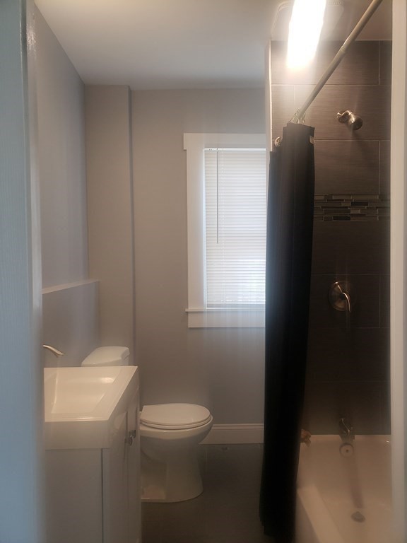 19 Wareham Street Springfield, MA 01108 - Photo 10 of 25 a white toilet sitting next to a bathroom sink